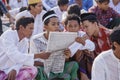 Four men read a newspaper after praying