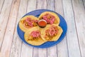 four Mexican corn tortilla tacos with a recipe for a cochinita pibil stew with red onion and dip sauce