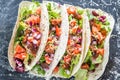 Four mexican tacos on a black background