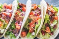 Four mexican tacos on a black background