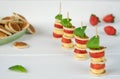 Four mini pancakes on a skewer with a mini banana, strawberries and fresh green mint.