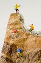 Miniature climbers climbing rocks Royalty Free Stock Photo