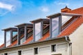 Four modern dormer window made of glass and metal. Lateral glass panels