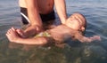 Four month old baby boy first time swimming in the sea