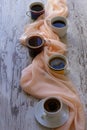 Four mugs of coffee and beige cloth Royalty Free Stock Photo