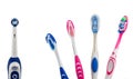 Four multi-colored manual toothbrushes and one electric Royalty Free Stock Photo