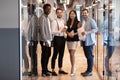 Multiethnic business people stands in office hallway pose for camera Royalty Free Stock Photo