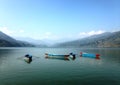 Four multicolore tourist boats of Lake Pheva, mountains and clouds Royalty Free Stock Photo