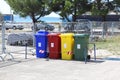 Four multicolored boxes for sorted garbage: red, green, blue and yellow. Recycling garbage in the tourist area. Infrastructure of