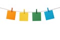 Four multicolored paper blank notes hanging on the rope with wooden clothespins isolated on white Royalty Free Stock Photo