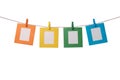 Four multicolored paper photo frames hanging on the rope with wooden clothespins isolated on white Royalty Free Stock Photo