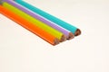 The four multicolour wooden pencils background on the white