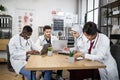 Four multiethnic doctors having conference at hospital Royalty Free Stock Photo