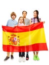 Four multiethnic teenage kids holding Spanish flag Royalty Free Stock Photo