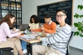 Four multiracial cheerful happy students studying together in classroom. Royalty Free Stock Photo