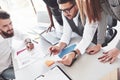 Four multiracial employee have work in the office using the laptop on table