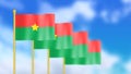 Four national flag of burkina Faso waving in wind focused