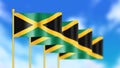 Four national flag of Jamaica waving in wind focused on first flag and blue sky