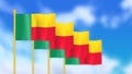 Four national flag of republic of Benin waving in wind focused on first flag