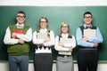 Four nerds in front of blackboard