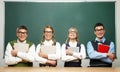 Four nerds holding books