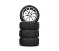 Four new good-looking snow tires isolated on the white background. A set of studded winter car tires. A set of wheels and tyre pac Royalty Free Stock Photo