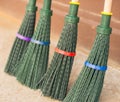 Four new green broom for cleaning foliage.