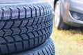 Four new snow tires on the backyard. A set of studded winter car tires. Black Rubber Tire. Vehicle Tires Royalty Free Stock Photo