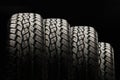 Four off-road tires close-up on a black background Royalty Free Stock Photo