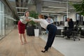 Four office workers warm up during a break. Employees do fitness exercises at the workplace.