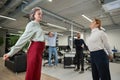 Four office workers warm up during a break. Employees do fitness exercises at the workplace.