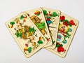 Four old ace cards from deck of playing cards with german suits - acorn, leaf, heart and bell, isolated on white background
