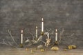 Four old burning advent candles on wooden rustic christmas background.