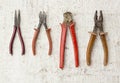 Four old fashioned repair tools pliers, nipples, wire-cutterson Royalty Free Stock Photo