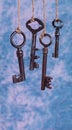 Four old keys hanging on blue Royalty Free Stock Photo