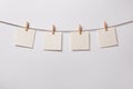 Four old paper blank notes hanging on the rope on white background Royalty Free Stock Photo
