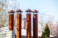 4 old rusted smoke chimneys on a roof