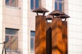 4 old rusted smoke chimneys on a roof