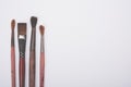 Four old used paintbrushes on white background Royalty Free Stock Photo