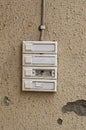 Four old and worn door bells on a beige wall Royalty Free Stock Photo