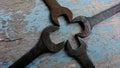 Four old wrenches form a cross formation Royalty Free Stock Photo