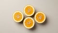 Four orange slices are arranged in a square pattern on a neutral background Royalty Free Stock Photo