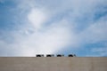 Four outdoor air conditioning units on a marble wall