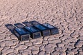 Four outdoor solar panel lanterns on the cracked dry ground