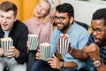 Group of friends watching television at home together Royalty Free Stock Photo