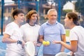 Four paddle tennis players talking on court Royalty Free Stock Photo