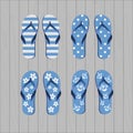 Four pair of different flip flops - blue white colors on grey wooden background