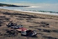 Four pair of flip flops at the beach Royalty Free Stock Photo