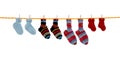 Four pairs of isolated handmade wool socks hanging on a rope. Royalty Free Stock Photo