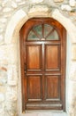 Four paneled, wood, front door with arching top of,four glass panels